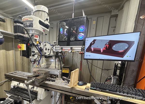 CNC Masters Supra mill with the bracket design on the monitor in the OffTheGridRVs machine shop