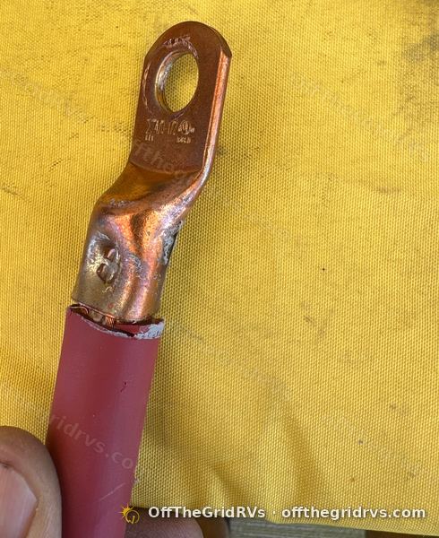 Factory hammer crimp on a bare copper lug with red 4/0 cable