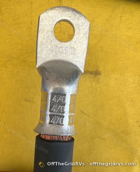 OffTheGridRVs hydraulic crimp on a tinned copper 4/0 lug, size stamped three times