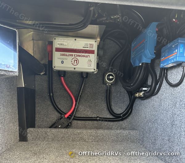 Finished Lithionics external BMS bay with Victron SmartSolar charge controllers and loomed cables