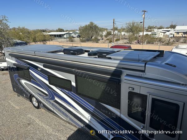 Side view of a 2022 Newmar New Aire diesel pusher with its roof solar array mounted on custom racks